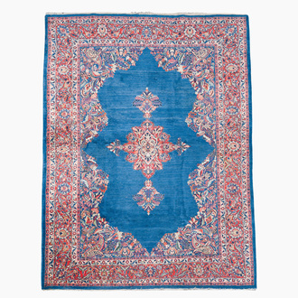 A Persian Sarouk rug with central medallion and floral design, wool on cotton, 20th C.