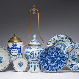 Five blue, white and polychrome Dutch Delft dishes, a lamp-mounted vase and a Brussels faience tobacco jar, 17th/19th C.