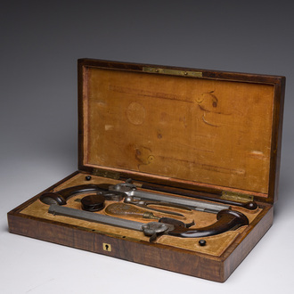 A French dueling box containing a pair of percussion pistols with damask barrels and engraved breechblocks, 19th C.