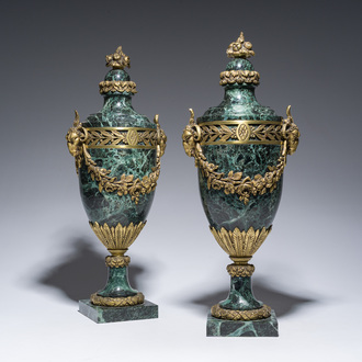 A pair of French Neoclassical vert de mer marble cassolettes mounted with gilt bronze rams' heads and floral garlands, 19th/20th C.