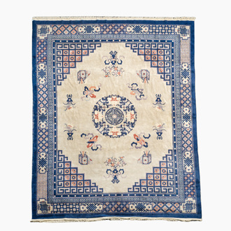 A Chinese Beijing rug with antiquities, floral design and stylized motifs, wool on cotton, 20th C.