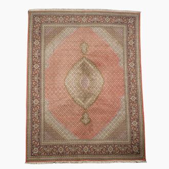 A Persian Tabriz rug with central medallion and floral design, wool on cotton, first half 20th C.