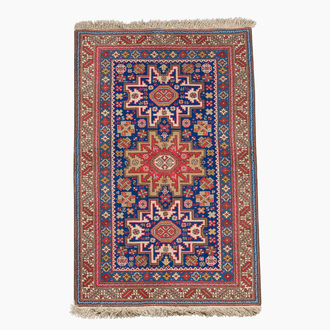 An Afghan Shirvan rug with geometric floral design, wool on cotton, mid 20th C.