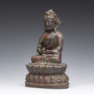 A Chinese gilt lacquered bronze sculpture of a seated Buddha, Ming