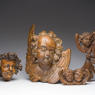 Four carved wooden angel heads, 17th C. and later