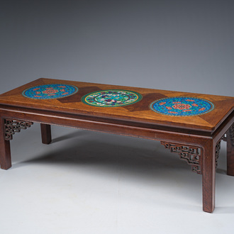 A Chinese rectangular wooden table inlaid with three round cloisonné plaques with floral design, 20th C.