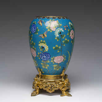 A Chinese cloisonné vase with butterflies among flowers mounted on a gilt bronze stand, 19th C.