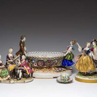 Two polychrome Saxon porcelain groups, a table piece and a cup and saucer, Germany, 19th/20th C.