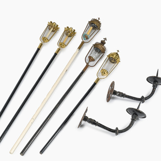 Five Gothic revival brass procession lanterns with patinated wooden poles and a pair of wrought-iron wall sconces, 19th/20th C.