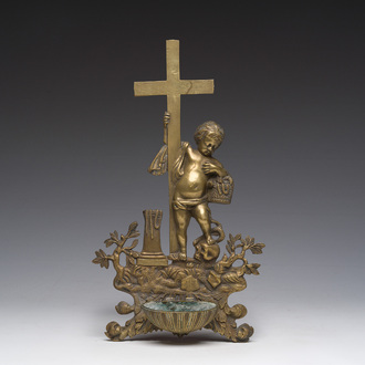 A bronze holy water font crowned by a putto surrounded by various instruments of the Passion, 19th C.