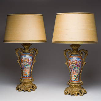 A pair of Chinese gilt bronze lamp mounted famille rose 'Mandarin' vases, Qianlong