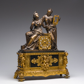 A French gilt bronze and black marble mantel clock crowned with two musicians, 19th C.