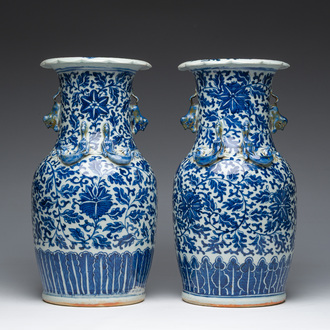 Two Chinese blue and white 'lotus scroll' vases with relief design, 19th C.