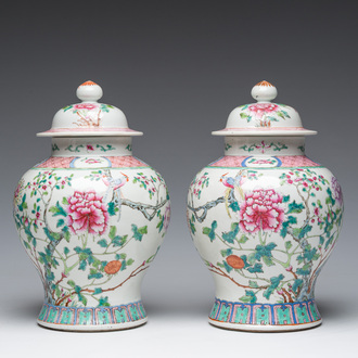 A pair of Chinese famille rose vases and covers with birds among blossoming branches, 19th C.