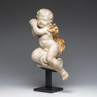 A Flemish patinated and gilt wooden angel mounted on a pedestal, 18th C.