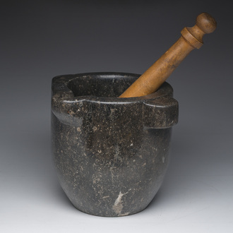 A French black marble mortar with a later wooden pestle, 18th/19th C.