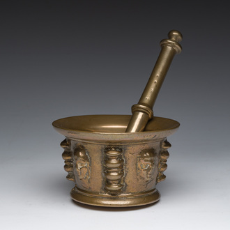 A French bronze 'mascarons' mortar with a pestle, presumably Le Puy-en-Velay, 16th/17th C.
