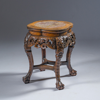 A Chinese openworked carved wooden stand with marble top, 19th/20th C.
