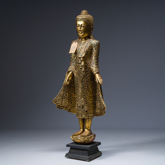 A Thai inlaid gilt wooden figure of a standing Buddha, 20th C.
