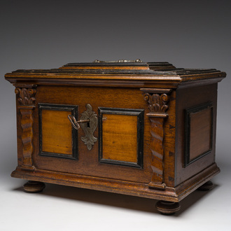 A German partially ebonized wooden (guild)chest with Solomonic columns and wrought iron mounts, 17th/18th C.