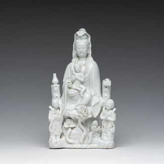 A Chinese Dehua blanc de Chine figure of Guanyin with servants, 19th C.