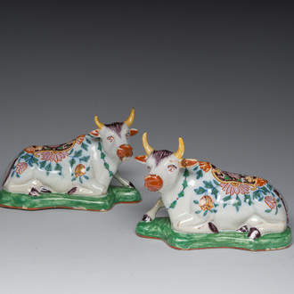 A pair of polychrome Dutch Delft style model of lying cows, Desvres, France, 19th C.