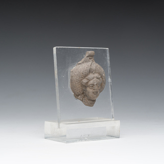 A Roman terracotta fragment of a bottle with a head in relief, probably 1st/3rd C.