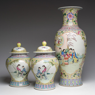 A Chinese famille rose yellow-ground baluster vase and a pair of vases and covers with animated scenes, Qianlong marks, Republic, 20th C.