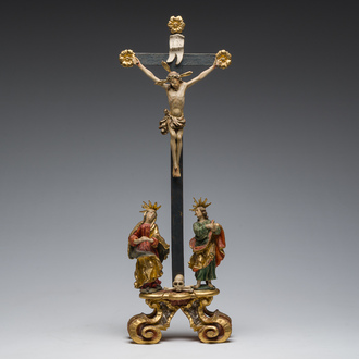 An Italian gilt and polychrome decorated wooden crucifixion group with Jesus on the cross flanked by Mary and John the Evangelist, 18th C.