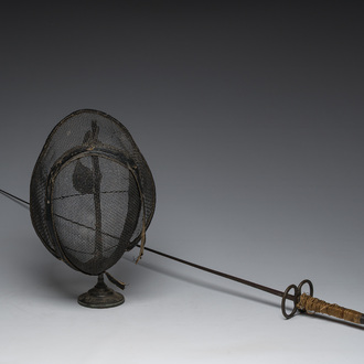 A French rapier and a fencing mask on a stand, 19th/20th C.