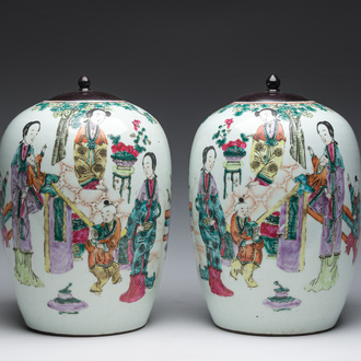 A pair of Chinese qianjiang cai jars and covers with ladies and children in a palace garden, 19th/20th C.