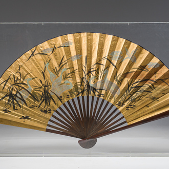 A large Japanese painted 'cranes in a landscape' folding fan luxuriously framed in a plexiglass box, signed, 20th C.