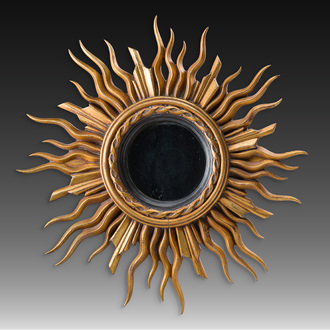 A large gilt and carved wooden sun mirror, 20th C.