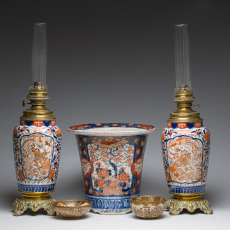 Two Japanese Satsuma bowls with animated scenes, an Imari jardinière with floral design and two vases mounted into lamps, Meiji, 19th/20th C.