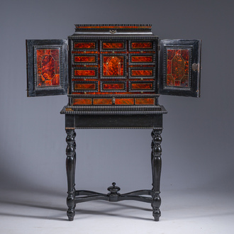 An ebonized wooden and tortoiseshell-veneered Antwerp cabinet on stand, 17th C. and later