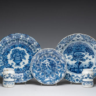Three Dutch Delft blue and white dishes with a bird and floral design and two pharmacy jars, 18th C.