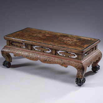 A Chinese rectangular carved and lacquered wooden low table with peach design, Qing