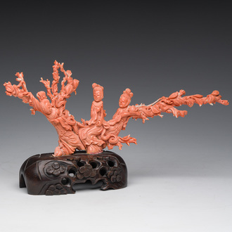 A Chinese red coral group with ladies during a tea ceremony in a garden, 19th/20th C.