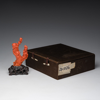 A Chinese red coral group with the 'Star God' Shou Xing and a lady, 19th/20th C.