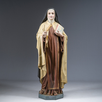 A large polychrome decorated plaster figure of Saint Teresa of Avila with glass eyes, 19th/20th C.