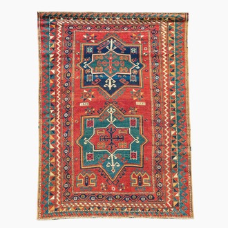 A Kazakh wool Fachralo rug with geometric and floral design, first half 20th C.