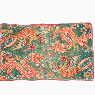 A Tibetan wool 'dragons and phoenixes' rug, 19th C.