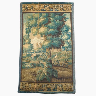 A Flemish wall tapestry with birds in a landscape with a castle in the background, 17th C.