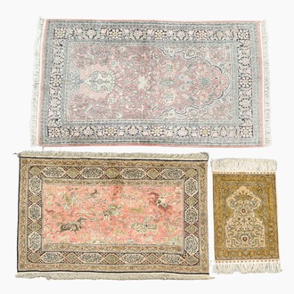 Three oriental silk rugs with hunting scenes and floral design, Hereke, Qom (Qum/Ghom) and Kashmir, 20th C.
