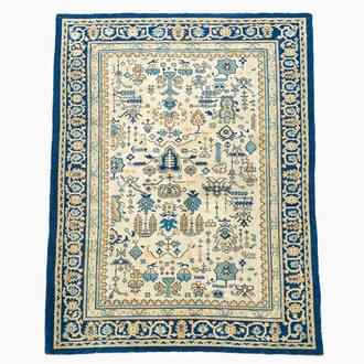 A Chinese wool carpet with floral geometric design, first quarter 20th C.