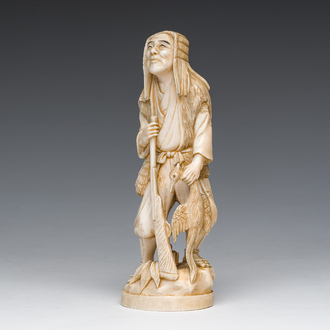 A Japanese ivory okimono of a hunter with his hunting trophy, signed, Meiji, ca. 1900