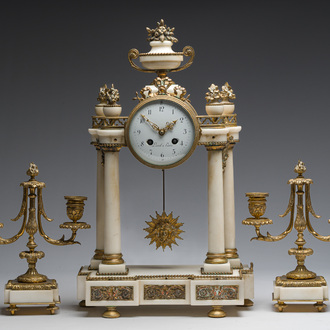 A French Louis XVI style three-piece gilt bronze mounted white marble clock garniture crowned with a flower basket, 19th C.