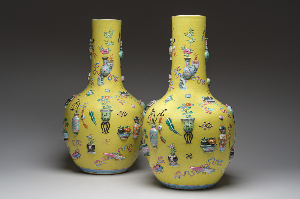 An exceptional pair of Chinese famille rose yellow sgraffito-ground bottle vases with applied design of antiquities, 19th C.