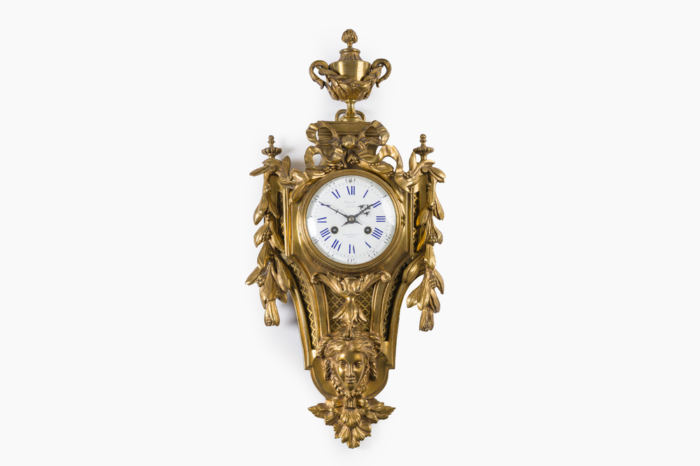A French gilt bronze Louis XVI style cartel clock with a mascaron and floral design, Collin &agrave; Paris, 19th C.