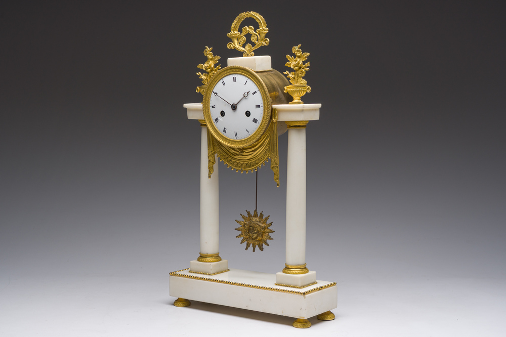 A French Neoclassical gilt bronze mounted white marble portico clock, 19th C.